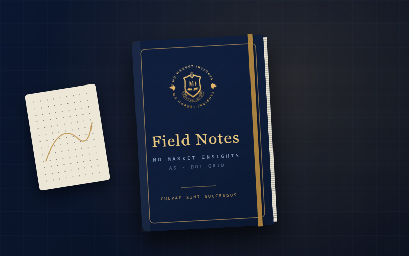 The Field Notebook — navy A5 notebook with gold-foil crest and dot-grid pages
